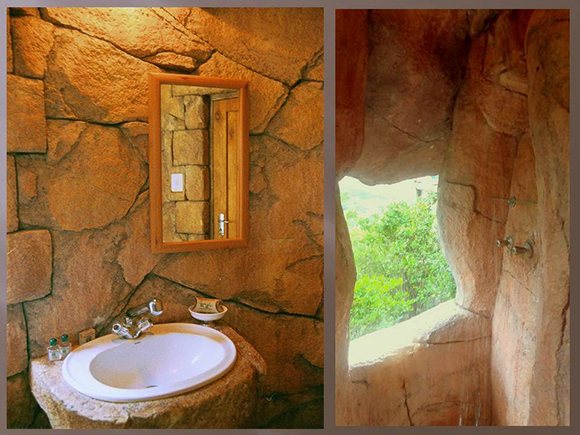 Sandstone basin and rock shower window in a Bush Camp bathroom.