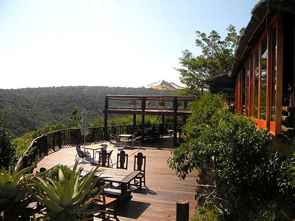 Tables laid for dinner under the thatched roof of the Sunset Lapa.