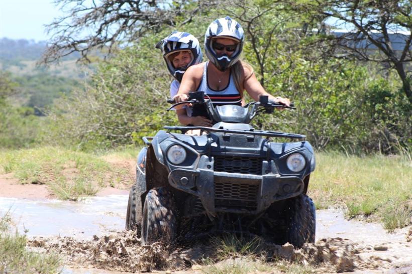 Quad bikes lined up on a track.