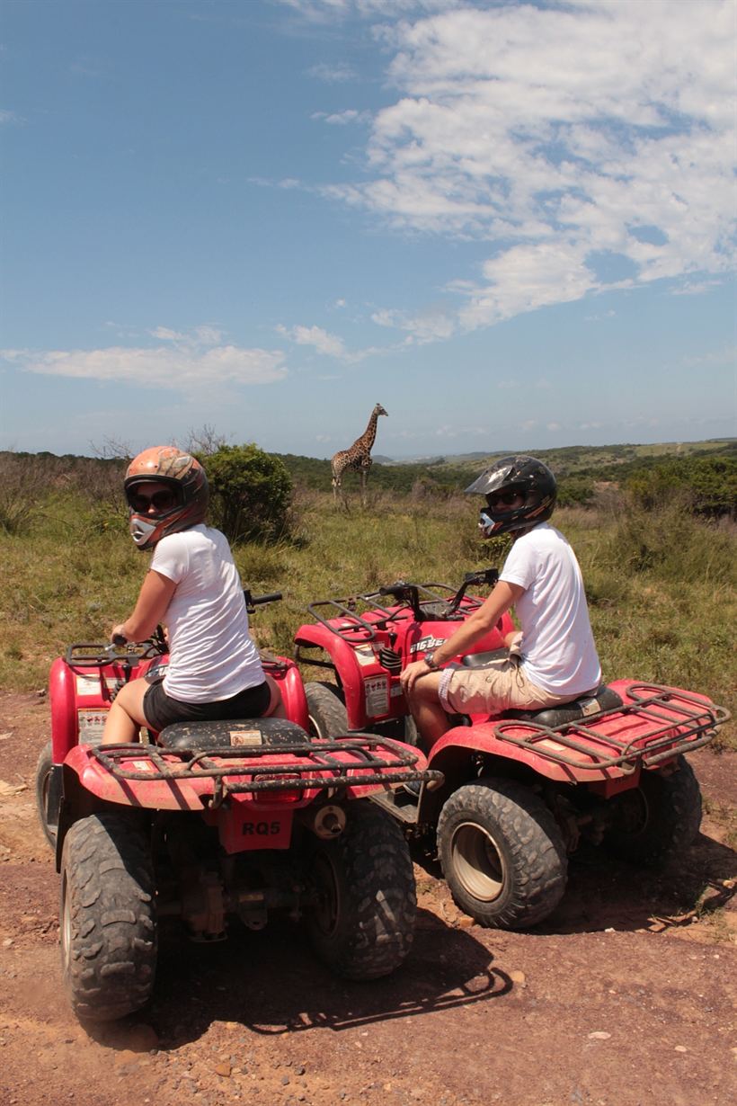 A quad bike on a narrow bush trail.